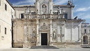 Seitenansicht des Doms in Lecce, Apulien, Italien in der Mittagshitze und leerem Platz 